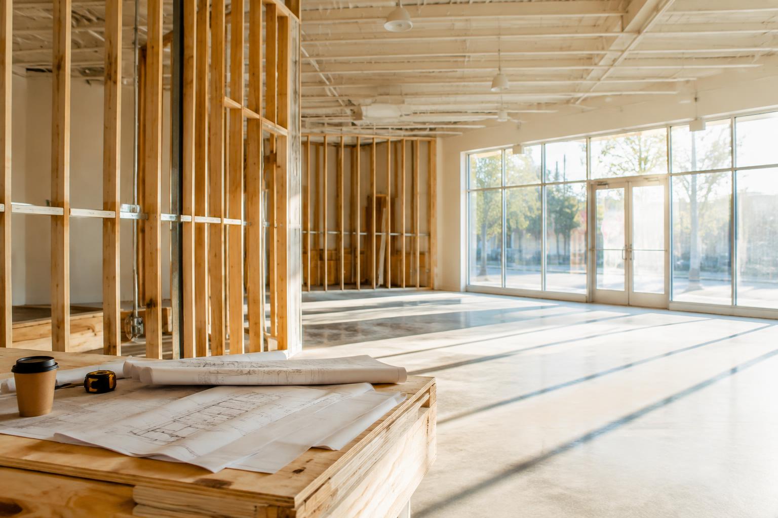 A retail space mid build-out with plans on a table